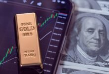 Gold bar on financial chart showing market outflow with US dollar bills in background